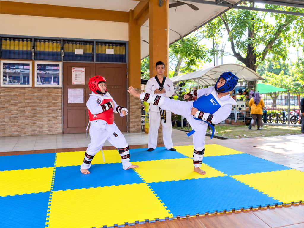 taekwondo sparring on colorful mats